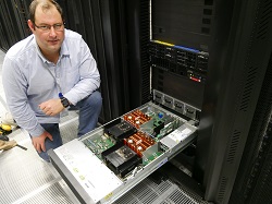 Dr Christopher Walker of the ITS Research Infrastructure team with the new computers 